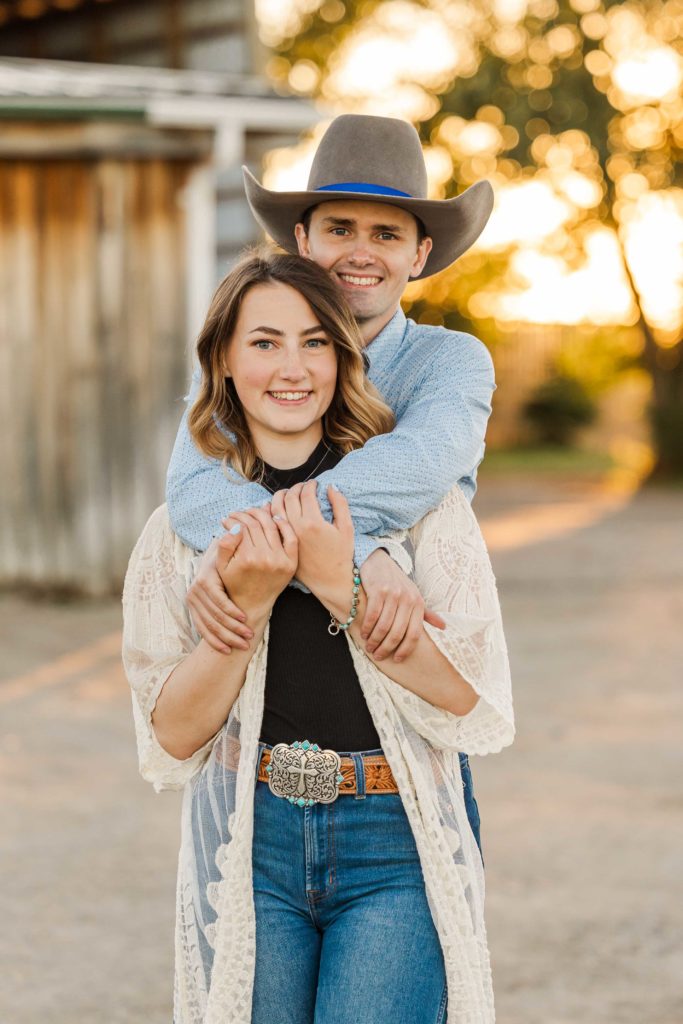 western couple posing at sunset